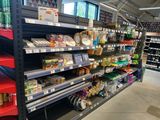 a lot of shelves in the store with food on them
