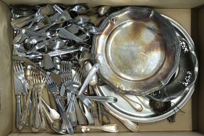 a box full of silverware and silver spoons in it