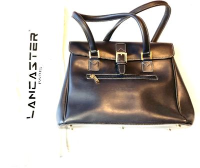 black leather handbag with two handles and a gold buckle