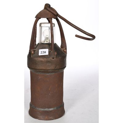 an old fashioned oil canister with a light on top of it