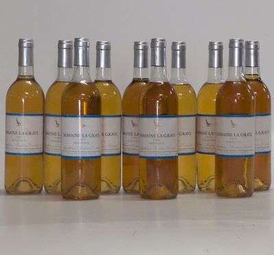 six bottles of wine are lined up in a row on a table
