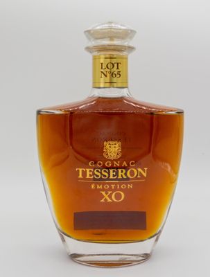 a close up of a bottle of liquor on a white surface