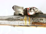 a gun with a skull on it on a white surface