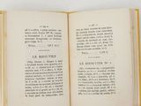 an open book on a white surface with a yellow border