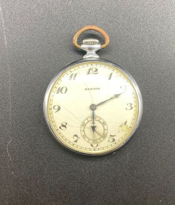 a silver pocket watch on a black surface