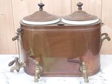 two brown pots sitting on top of a wooden table