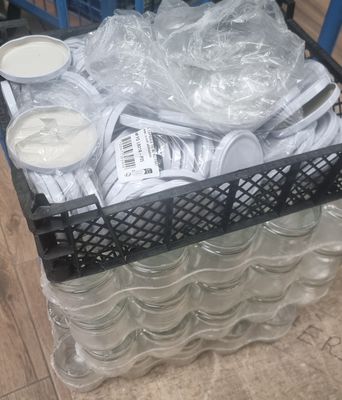 a cart full of plastic cups and spoons on the floor