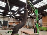 a machine that is working on a piece of wood in a building