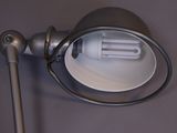 a lamp that is on a wall next to a lamp