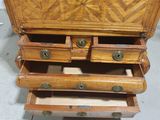 a wooden chest of drawers with drawers on top of it