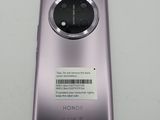 a close up of the back of a purple phone with a barcode on it