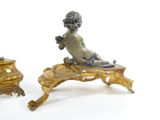pair of antique bronze figurines of a boy on a bench