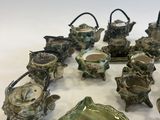 many pieces of pottery that are sitting on a table