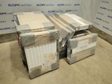 two stacks of boxes sitting next to each other on the floor