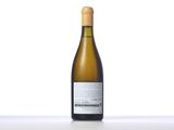 the bottle of white wine is sitting on the table