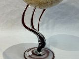 a glass bowl that is sitting on a stand