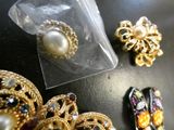 a bag of jewelry sitting on a table next to a pair of shoes
