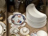 many plates and bowls in a box on the table