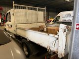 a white truck that is parked in a garage