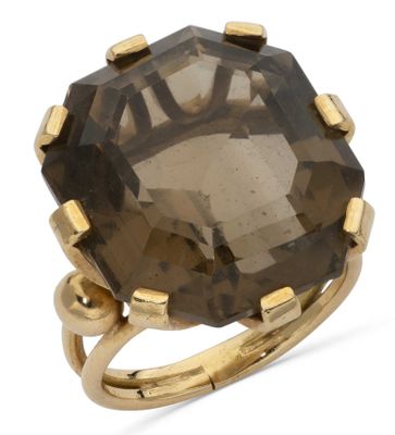 a close up of a ring with a large brown stone