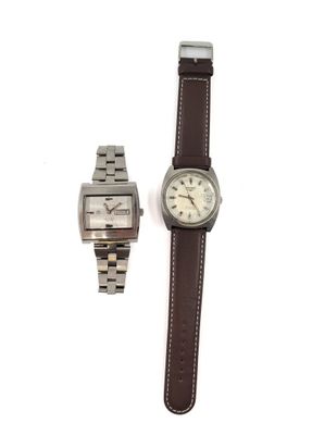 two watches that are sitting next to each other on a table