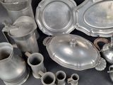 a lot of silver items that are sitting on a table