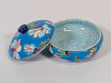 a small bowl with a lid on a white surface