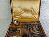a wooden box with silverware in it on a table