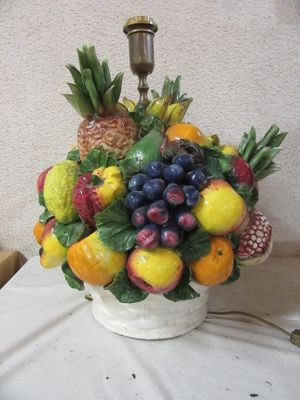 a vase with a bunch of fruit in it on a table