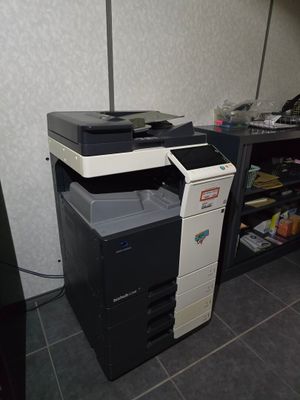 a black and white printer sitting on top of a desk