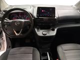 the interior of a small car with a steering wheel and dashboard controls
