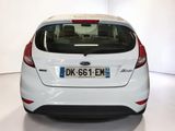 a white car that is parked in a white room