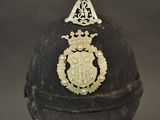 an old helmet with a crest on the front and a shield on the back