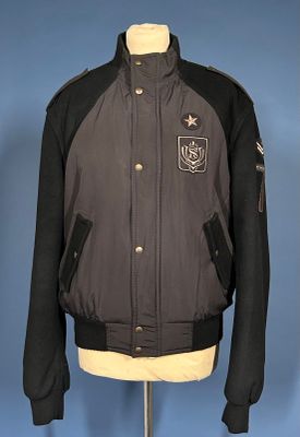 black and grey bomber jacket on a mannequin stand