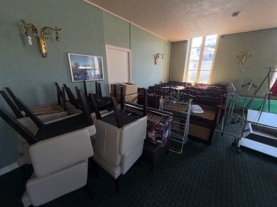 a room with a lot of chairs and a television on the wall
