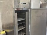 a large stainless steel refrigerator in a kitchen with shelves