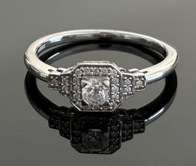 a picture of a diamond ring on a black surface