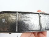 a person holding a metal object in their hand