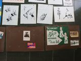 a lot of posters on the wall of a building