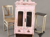 dollhouse furniture including a pink cabinet, chair, and side table