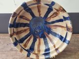 a blue and white bowl sitting on a wooden table