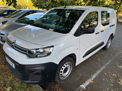 a white van parked in a parking lot next to other cars