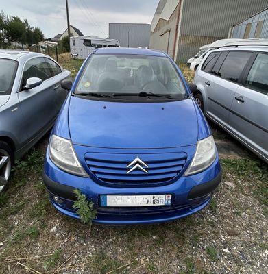 une voiture bleue garée à côté d'autres voitures dans un parking