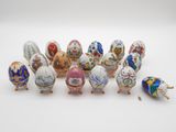 un ensemble de sept œufs en porcelaine ornés de motifs variés