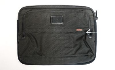 une valise noire posée sur une surface blanche