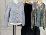 two jackets and a skirt on a stand in a room