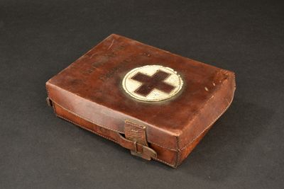 a brown leather case with a white cross on it