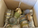 a cardboard box filled with many different colored jars