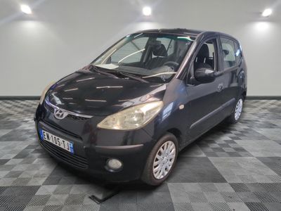 a picture of a small black car on a checkered floor