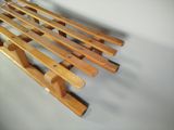 a wooden slatt hanging on a wall next to a white wall